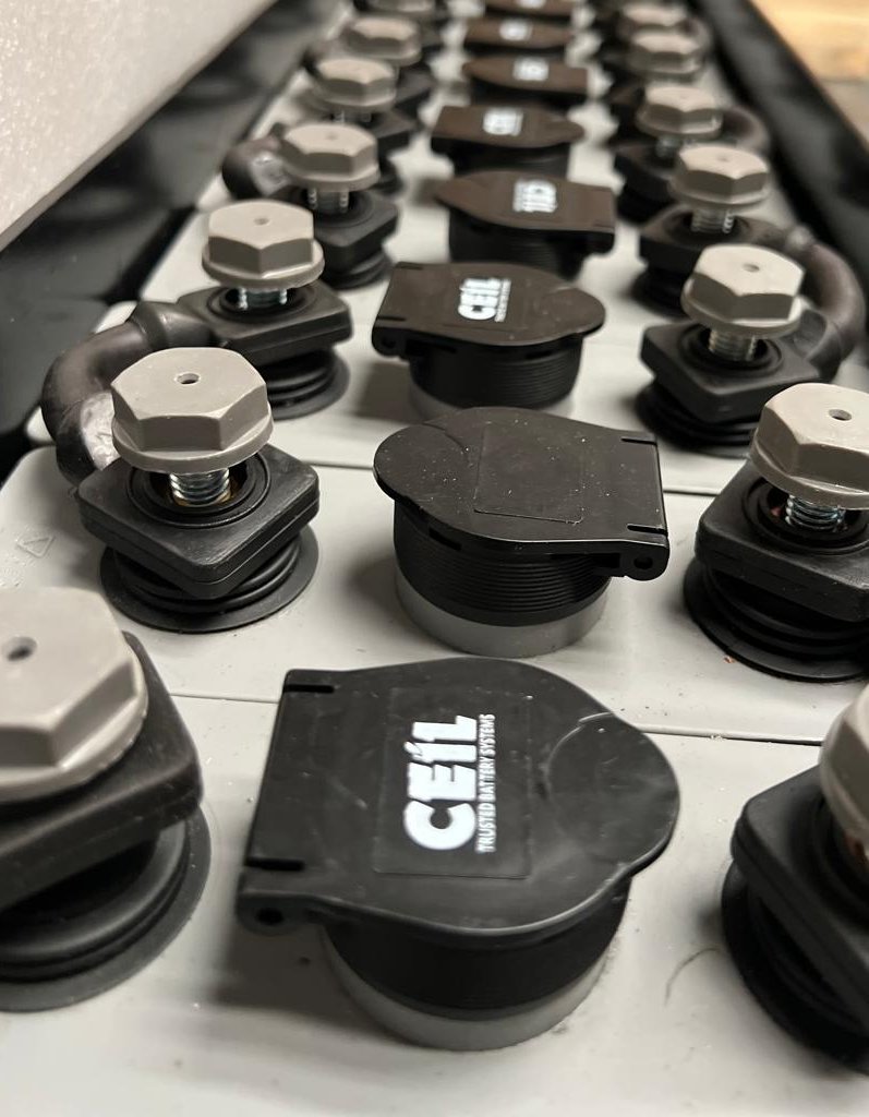 CEIL-branded vent plug caps on the top of a lead-acid industrial battery cell array.