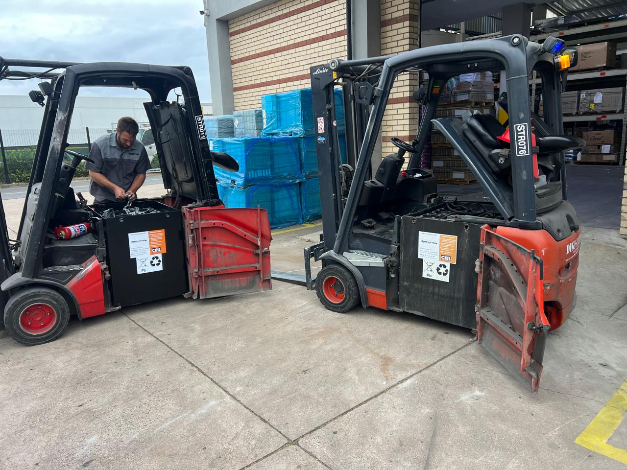 Ampwise technician servicing industrial batteries on-site across a client's forklift fleet.